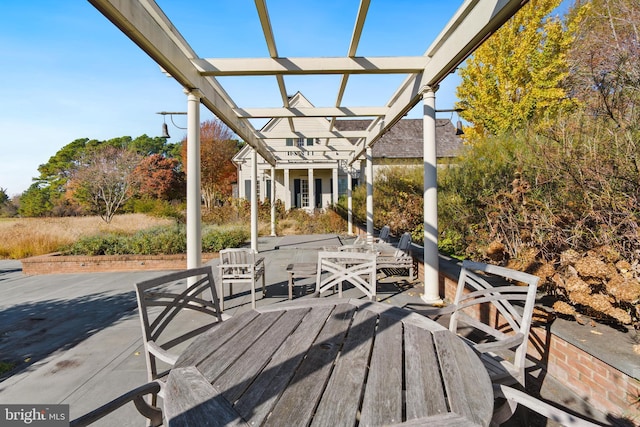 wooden deck featuring a pergola and a patio area