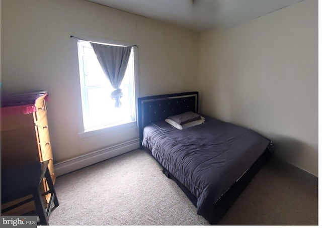 carpeted bedroom with a baseboard heating unit