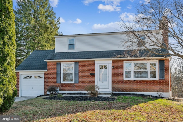 front facade with a front yard and a garage