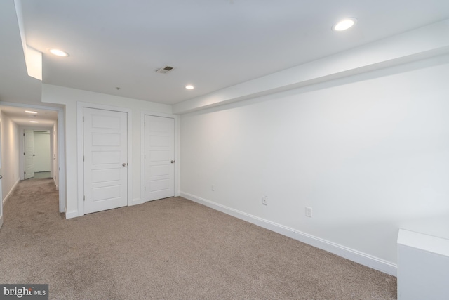 unfurnished bedroom featuring recessed lighting, baseboards, and light colored carpet