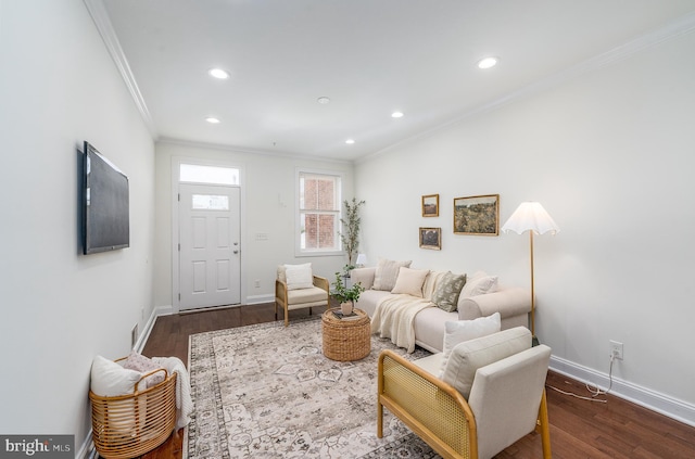 living room with ornamental molding, dark wood-style flooring, and baseboards