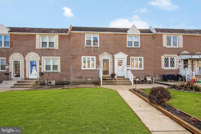 view of property with a patio area and a front yard