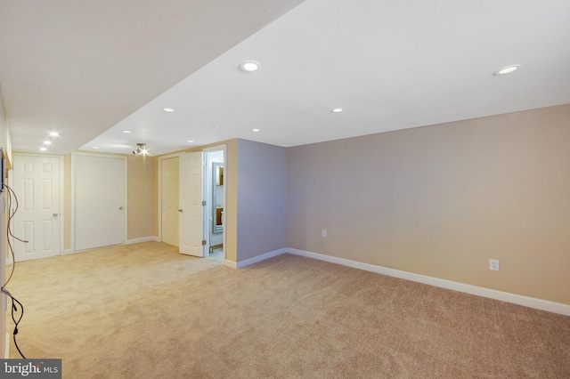 basement featuring light colored carpet