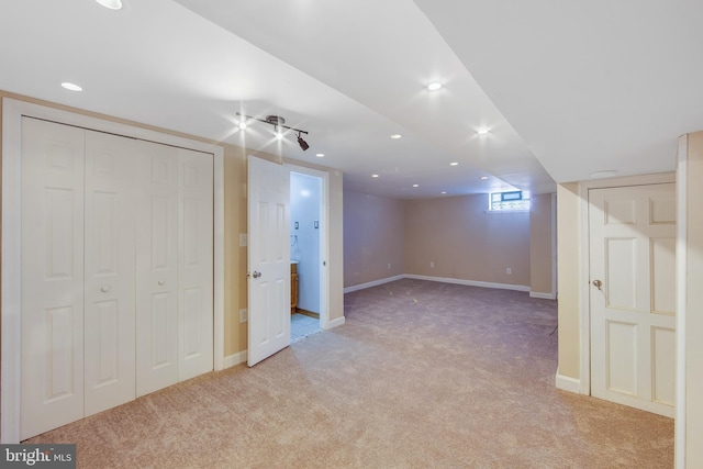 basement featuring light carpet