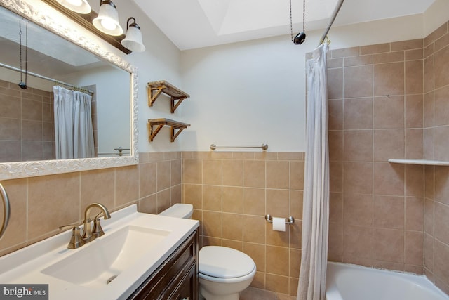 full bathroom featuring shower / bath combination with curtain, toilet, tile walls, and vanity