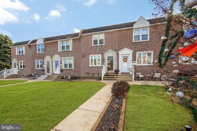 townhome / multi-family property featuring a front yard