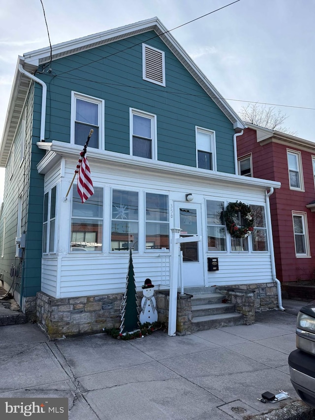 view of front of house with a sunroom