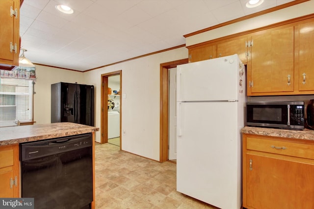 kitchen featuring washer / dryer, crown molding, and black appliances