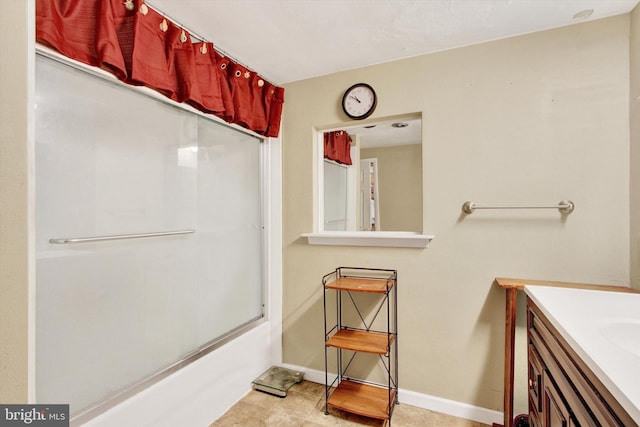 bathroom featuring vanity and bath / shower combo with glass door