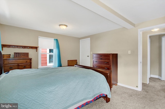 carpeted bedroom featuring beam ceiling