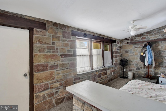 interior space with ceiling fan and lofted ceiling