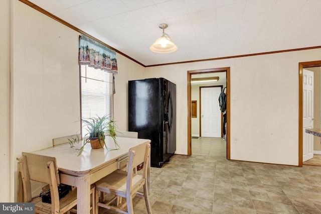 dining space featuring crown molding