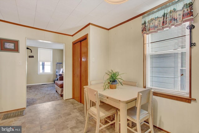 dining area featuring crown molding