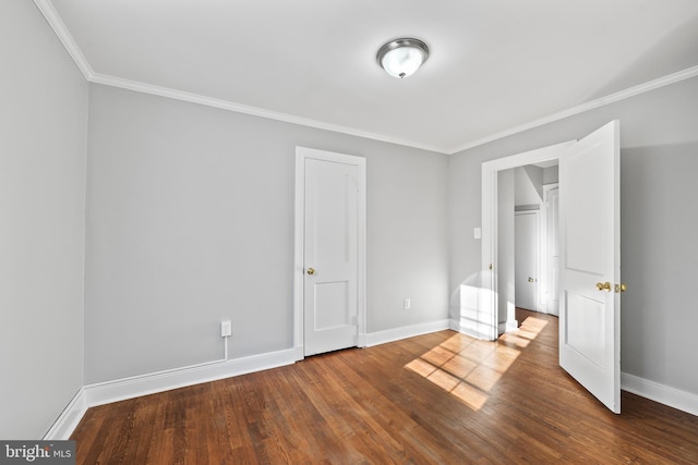 unfurnished bedroom featuring crown molding, baseboards, and wood finished floors