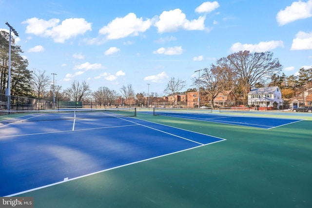 view of tennis court with fence