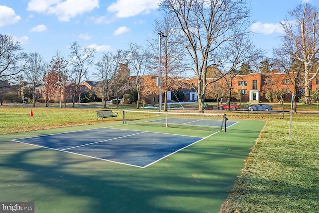 view of sport court featuring a yard