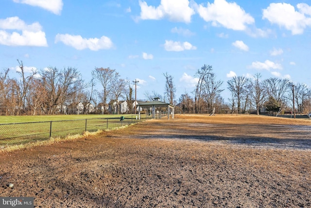 view of yard featuring fence and a rural view