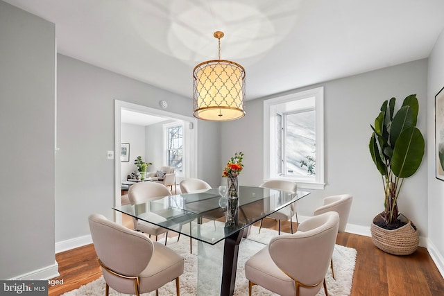 dining room with dark wood finished floors and baseboards