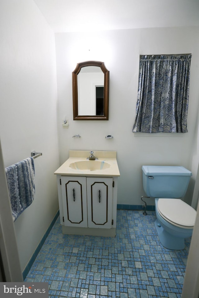 bathroom with toilet and vanity