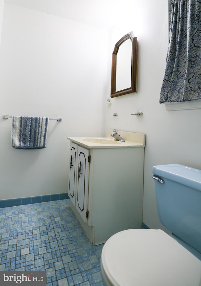 bathroom featuring toilet and vanity