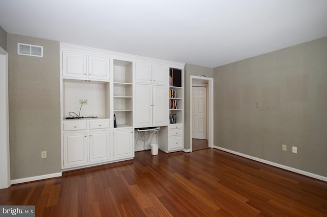 unfurnished bedroom with dark hardwood / wood-style floors