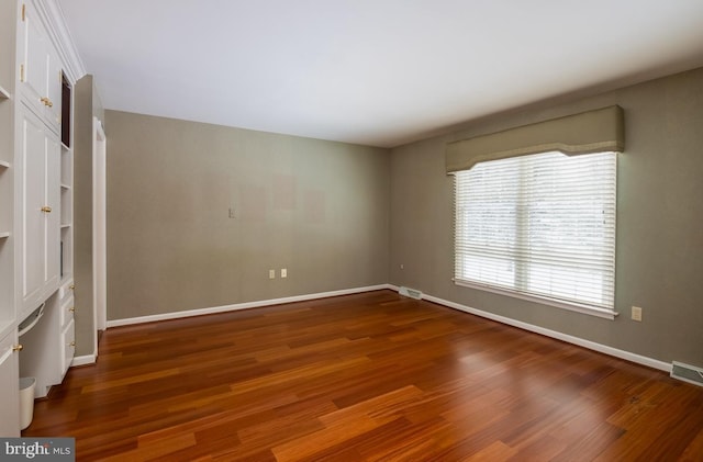 empty room featuring dark hardwood / wood-style flooring