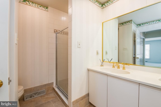 bathroom featuring vanity, toilet, and walk in shower