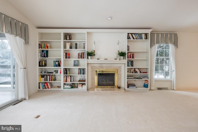 living room with carpet and a fireplace