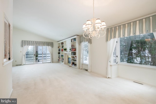 interior space featuring vaulted ceiling and an inviting chandelier