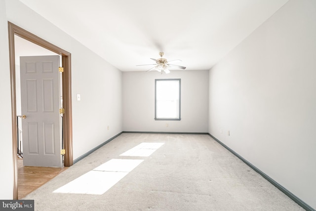 unfurnished room featuring ceiling fan and light carpet