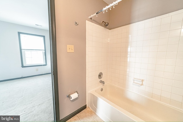 bathroom with tile patterned floors and tiled shower / bath