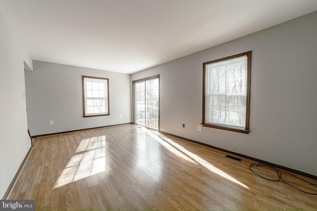 unfurnished room with light hardwood / wood-style floors