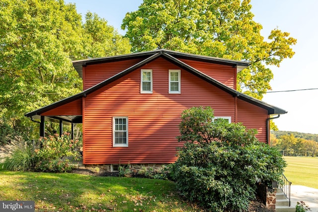 view of home's exterior with a lawn