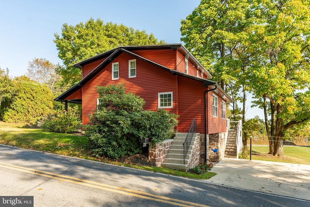 view of property exterior with a lawn