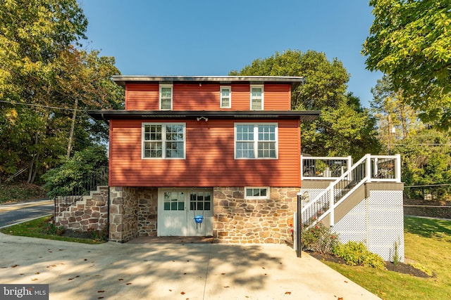 rear view of house with a wooden deck