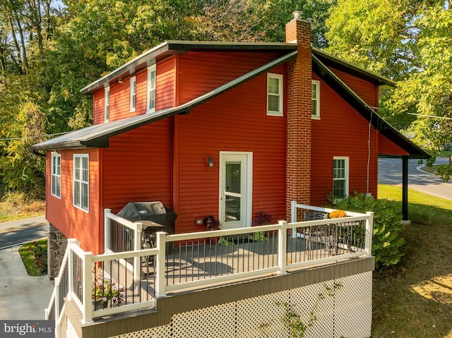 back of house with a wooden deck