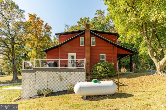 view of side of property with a lawn and a deck