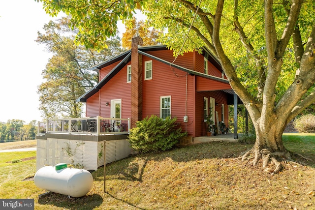 view of side of home featuring a patio and a deck