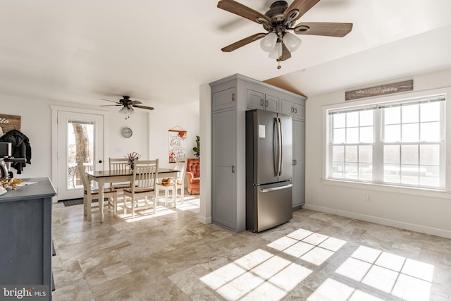 kitchen with stainless steel fridge, gray cabinets, and ceiling fan