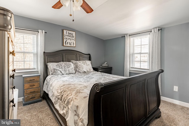 carpeted bedroom with ceiling fan and vaulted ceiling