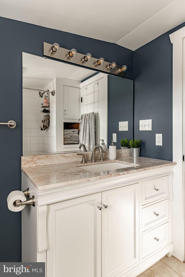 bathroom featuring tile patterned flooring and vanity