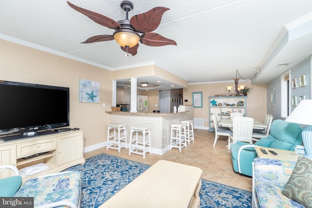 living room featuring crown molding, light tile patterned floors, ceiling fan with notable chandelier, and a textured ceiling