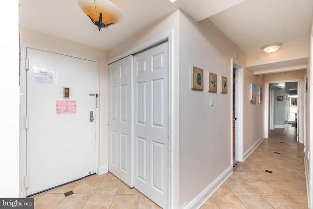 corridor featuring light tile patterned floors