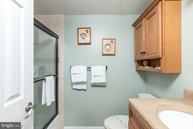 full bathroom with vanity, toilet, and enclosed tub / shower combo