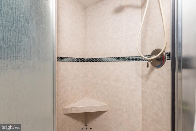 bathroom with a tile shower