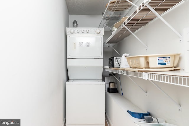 laundry area featuring stacked washer and dryer