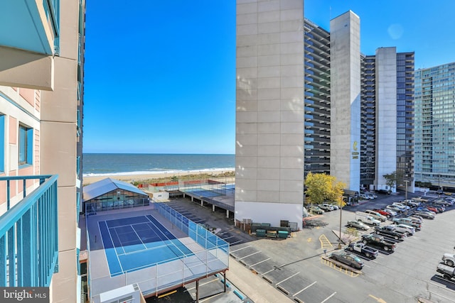 exterior space featuring a water view and tennis court