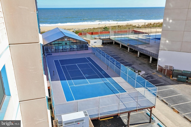 birds eye view of property with a water view and a view of the beach