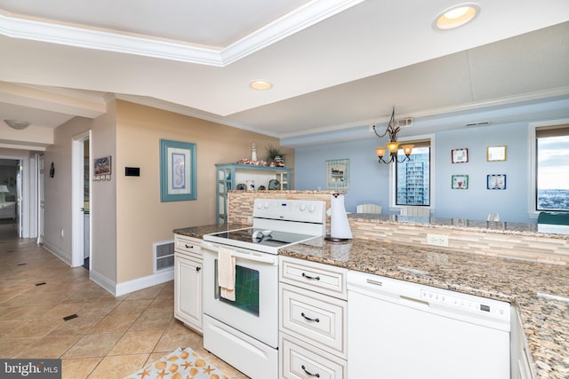 kitchen with light stone countertops, white cabinetry, a chandelier, white appliances, and ornamental molding