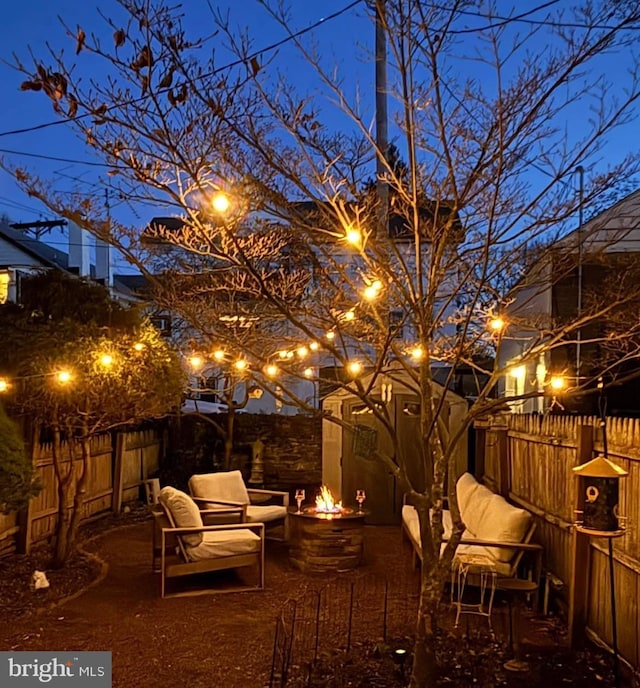 view of yard featuring a patio area, a fire pit, and a fenced backyard